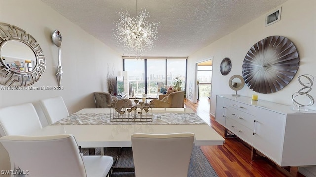 dining room featuring expansive windows, dark hardwood / wood-style floors, a notable chandelier, and a textured ceiling