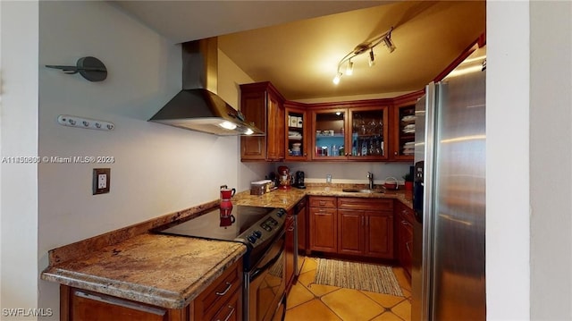 kitchen featuring sink, stainless steel fridge, electric range, light stone countertops, and wall chimney exhaust hood