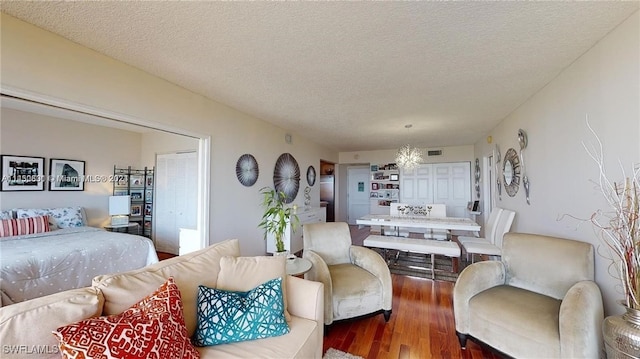 living room featuring dark hardwood / wood-style floors and a textured ceiling