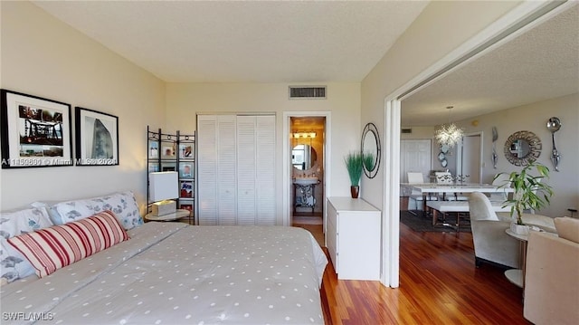 bedroom with hardwood / wood-style floors, a closet, and a textured ceiling