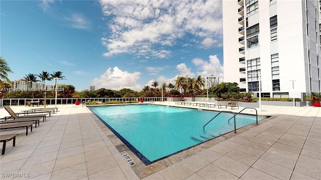 view of swimming pool with a patio