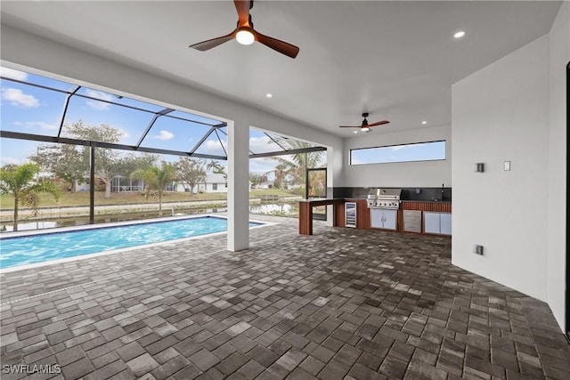 view of pool featuring a water view, area for grilling, and ceiling fan