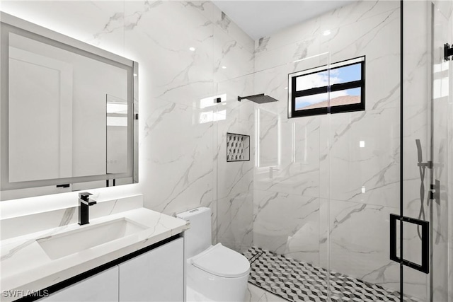 bathroom with vanity, a tile shower, and toilet