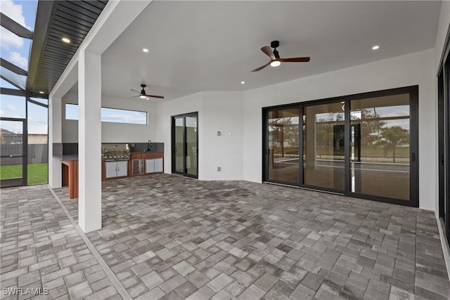 view of patio featuring sink, grilling area, ceiling fan, and exterior kitchen