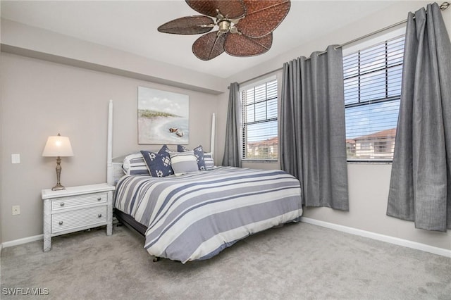 carpeted bedroom featuring ceiling fan and baseboards