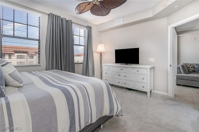 bedroom featuring a ceiling fan, light colored carpet, visible vents, and baseboards