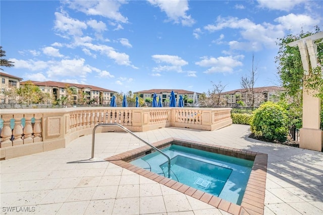 view of pool featuring a residential view, a patio, and a hot tub