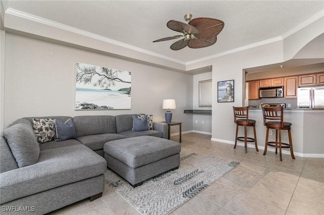 living area featuring a ceiling fan, baseboards, crown molding, and light tile patterned flooring