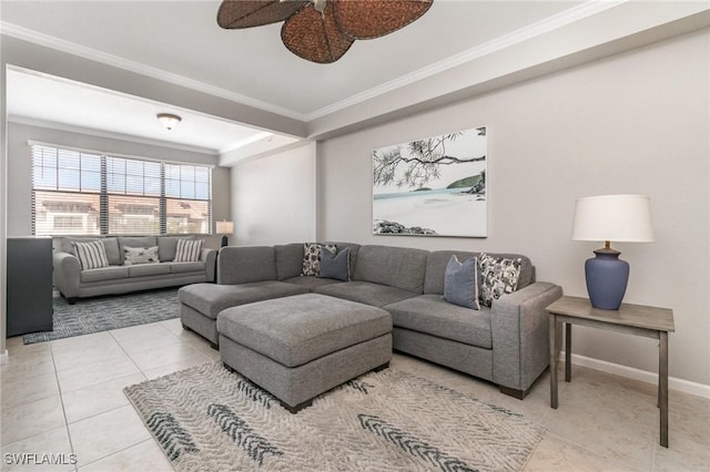 tiled living area featuring baseboards, a tray ceiling, a ceiling fan, and crown molding