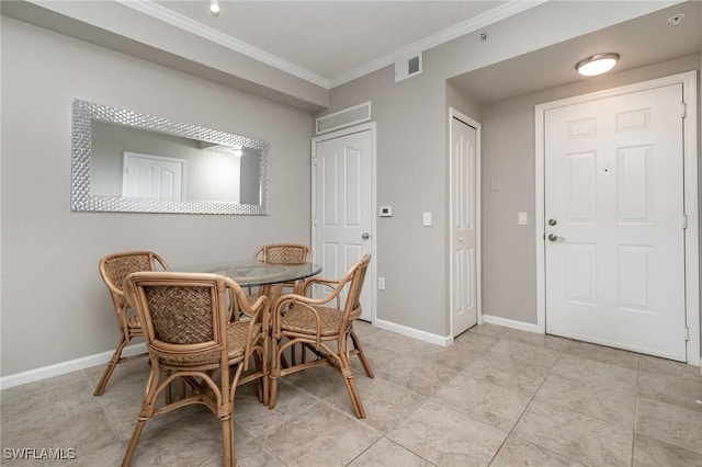 dining room with ornamental molding, visible vents, and baseboards