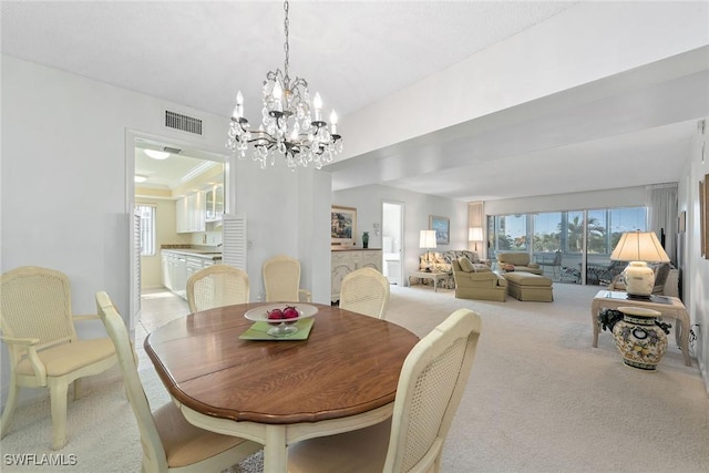 carpeted dining space featuring an inviting chandelier