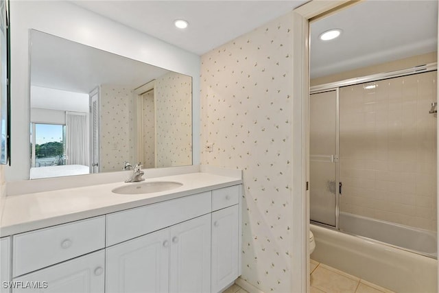 full bathroom with toilet, tile patterned floors, shower / bath combination with glass door, and vanity