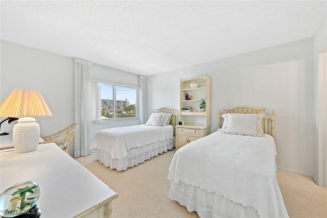 bedroom featuring light colored carpet and a textured ceiling