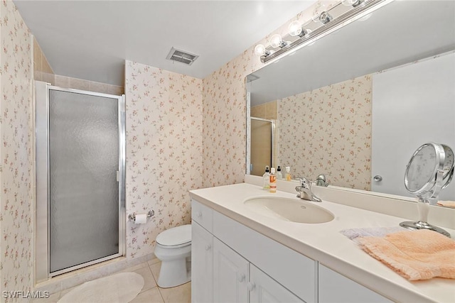 bathroom with tile patterned flooring, vanity, toilet, and walk in shower