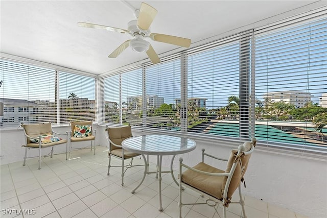 sunroom / solarium featuring ceiling fan