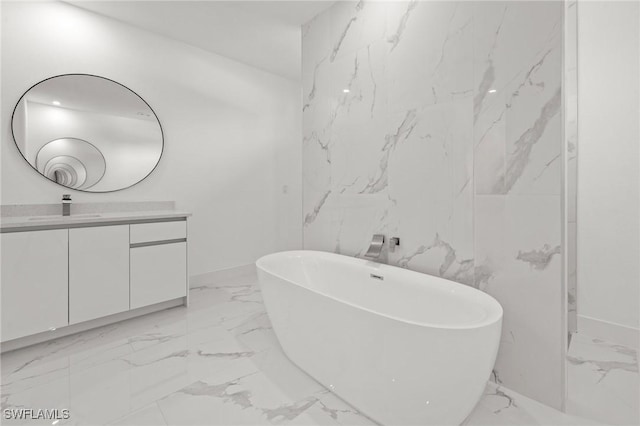 bathroom featuring vanity and a bath