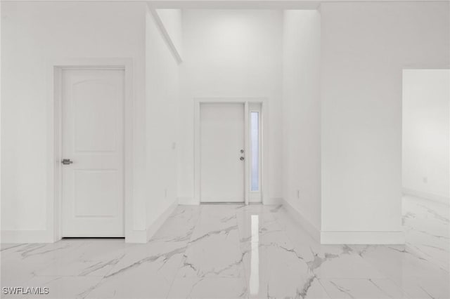 interior space featuring marble finish floor and baseboards