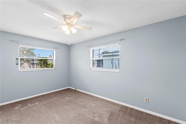 empty room with carpet flooring, a textured ceiling, and ceiling fan