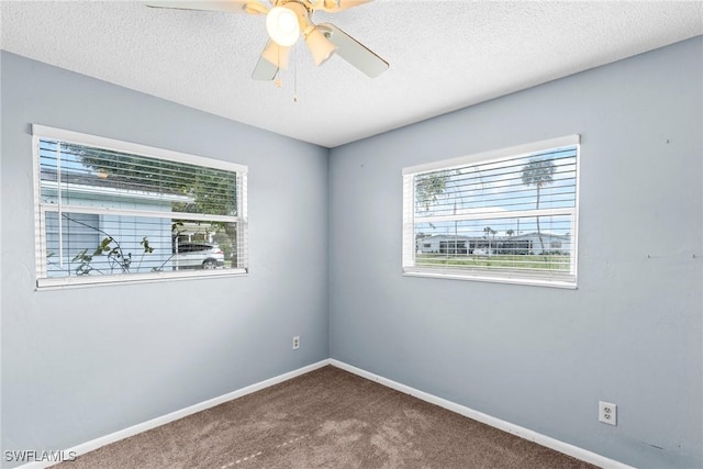 carpeted spare room with ceiling fan and a textured ceiling