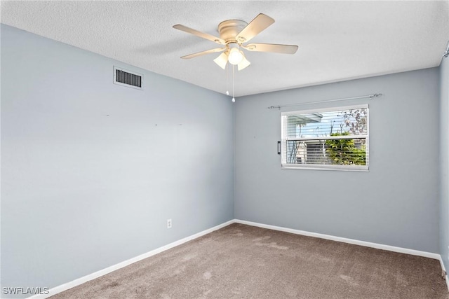 carpeted empty room with a textured ceiling and ceiling fan