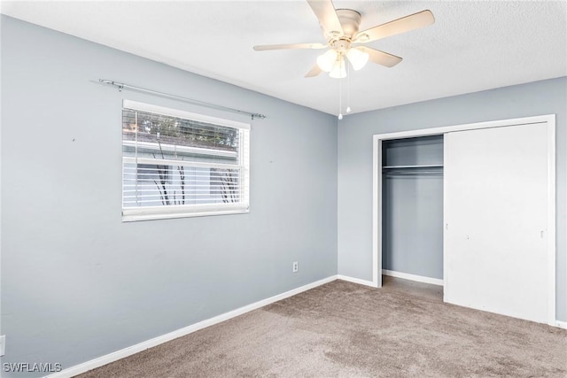 unfurnished bedroom with carpet floors, a closet, and ceiling fan