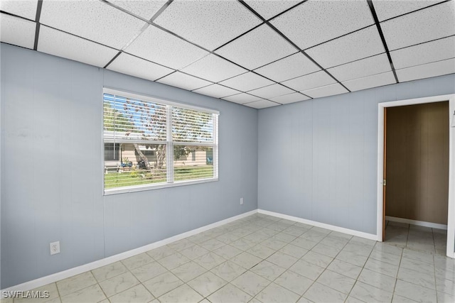 empty room featuring a paneled ceiling