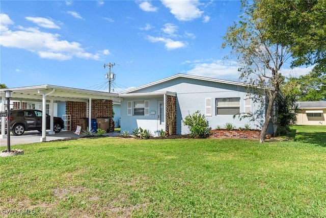 ranch-style house featuring a carport and a front lawn