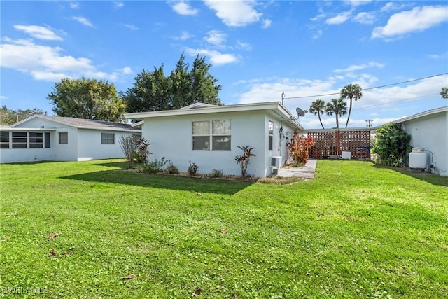 rear view of house with a yard