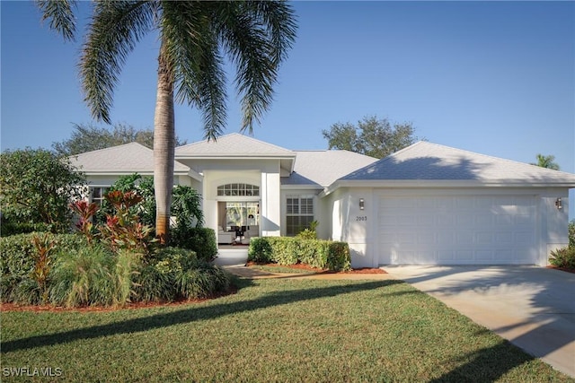 ranch-style house featuring a garage and a front lawn