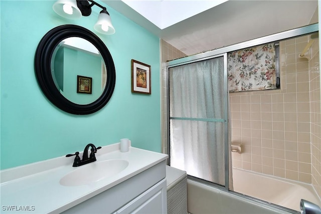 bathroom featuring vanity and bath / shower combo with glass door