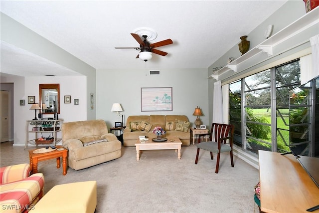 living room featuring carpet and ceiling fan