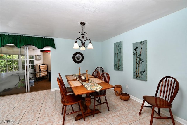 tiled dining room with a notable chandelier