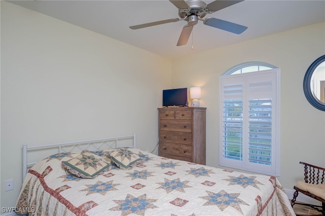 bedroom featuring multiple windows and ceiling fan