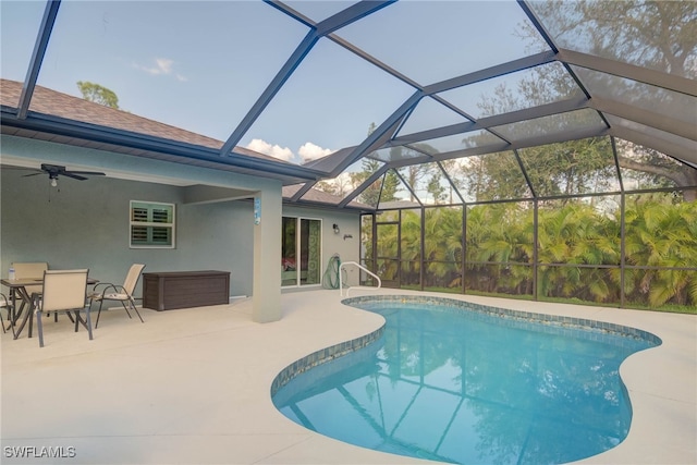 view of swimming pool featuring a lanai, a patio area, and ceiling fan