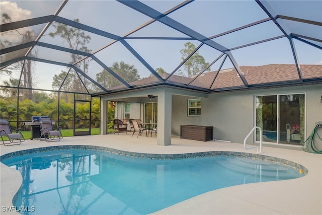 view of swimming pool with ceiling fan, a lanai, area for grilling, and a patio