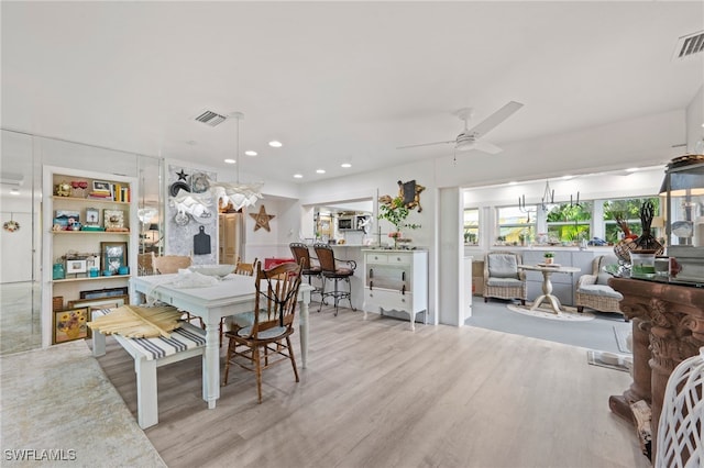 dining area with light hardwood / wood-style flooring and ceiling fan