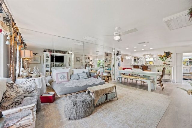 living room featuring hardwood / wood-style flooring and ceiling fan