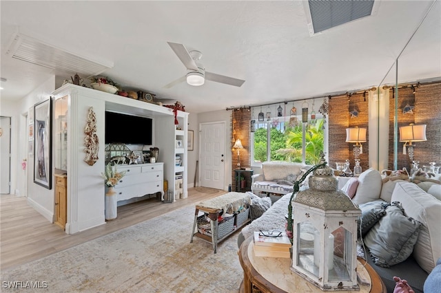 living room featuring ceiling fan and light wood-type flooring