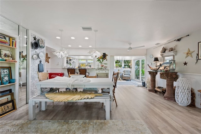 dining room with ceiling fan and light hardwood / wood-style floors