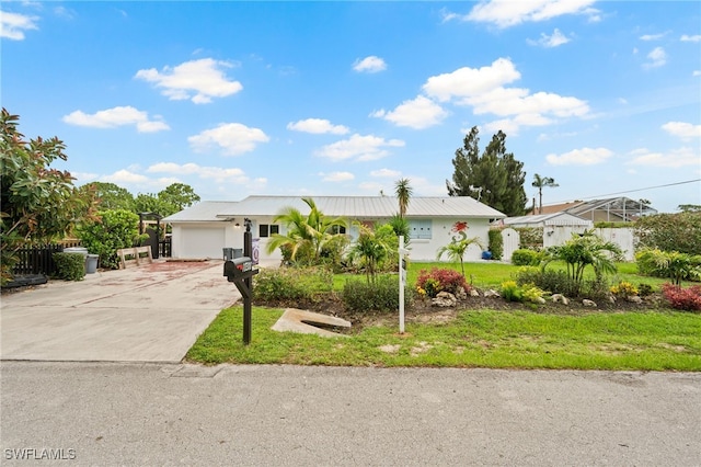 ranch-style home featuring a garage and a front lawn