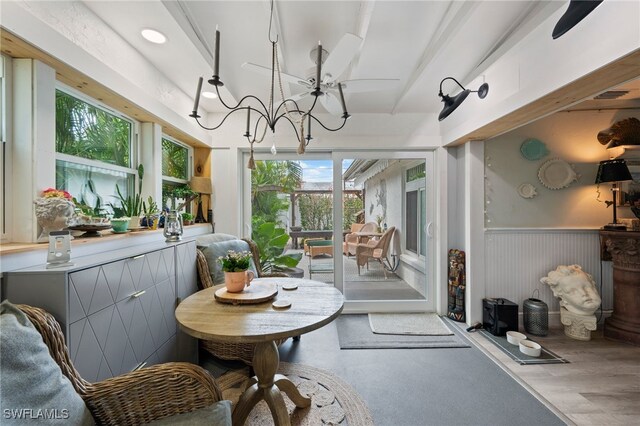 sunroom featuring a notable chandelier