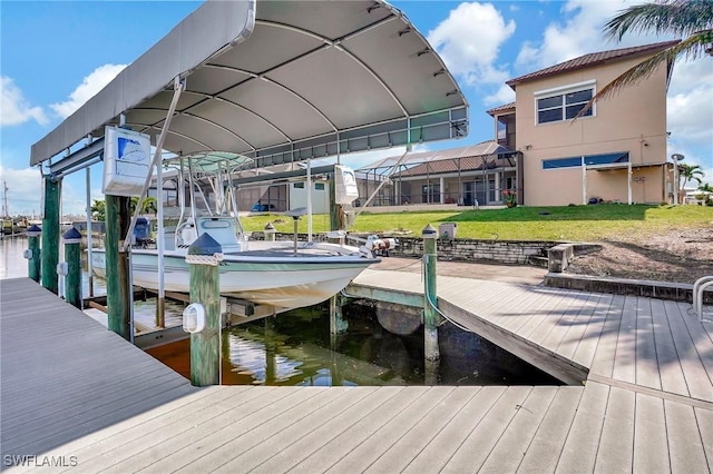 view of dock with a water view and a lawn