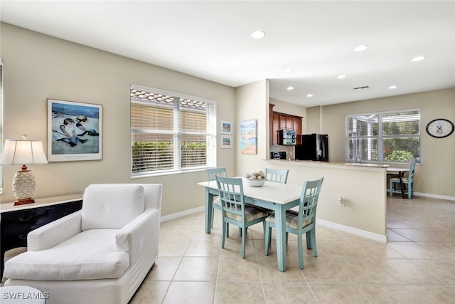 dining area with recessed lighting, baseboards, and light tile patterned floors