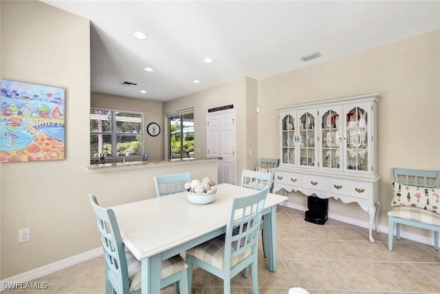 dining space featuring light tile patterned floors