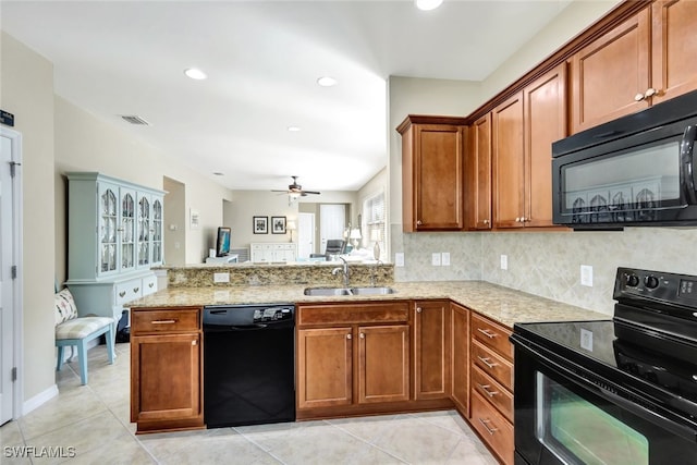 kitchen with black appliances, sink, backsplash, light tile patterned floors, and kitchen peninsula