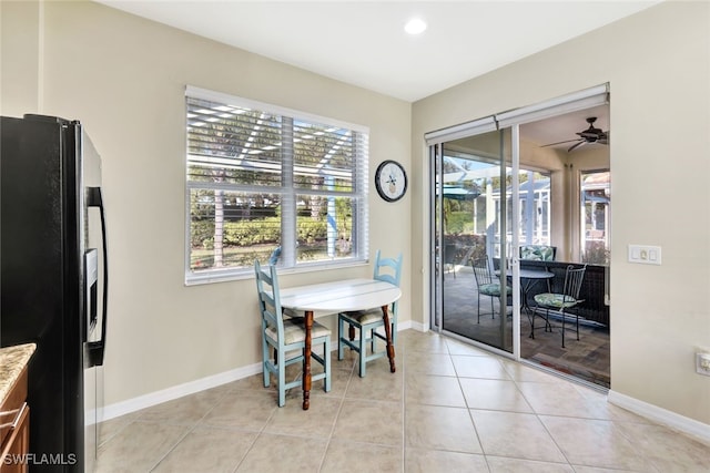 dining space with light tile patterned floors and ceiling fan