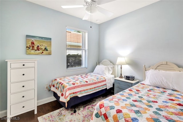 bedroom with dark hardwood / wood-style floors and ceiling fan