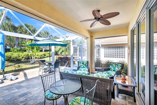 sunroom / solarium featuring ceiling fan