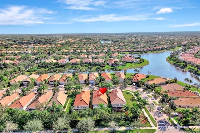 drone / aerial view featuring a water view and a residential view