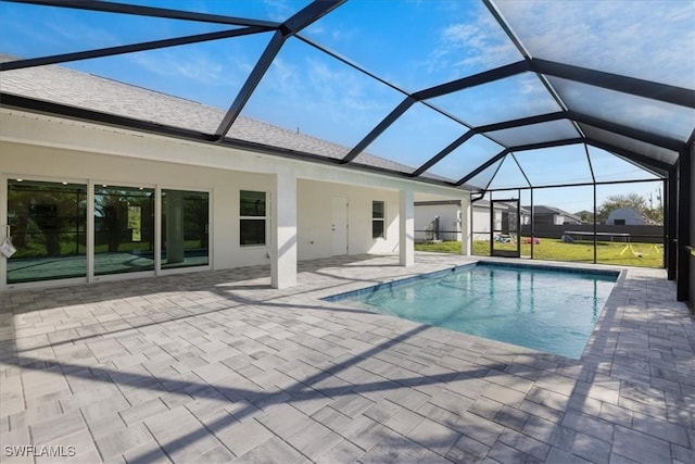 view of pool featuring a patio and glass enclosure